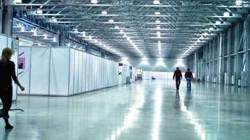Large exhibition hall with bright overhead lighting