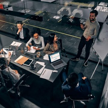 Overhead view of a team meeting in a well lit office