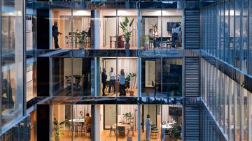Interior de oficina moderno con grandes ventanales e iluminación brillante
