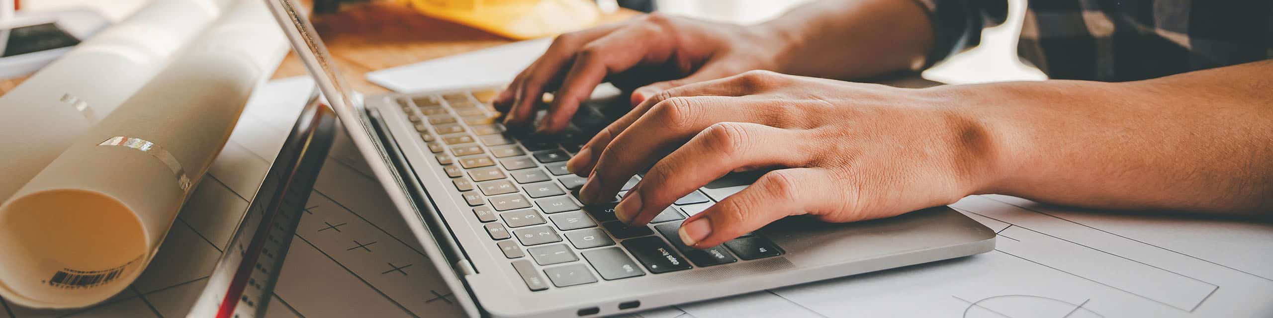 Hands interacting with a laptop keyboard