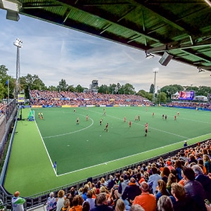 Outdoor hockey stadium with crowd