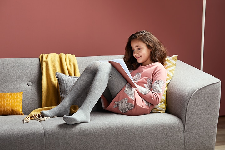 girl reading on couch