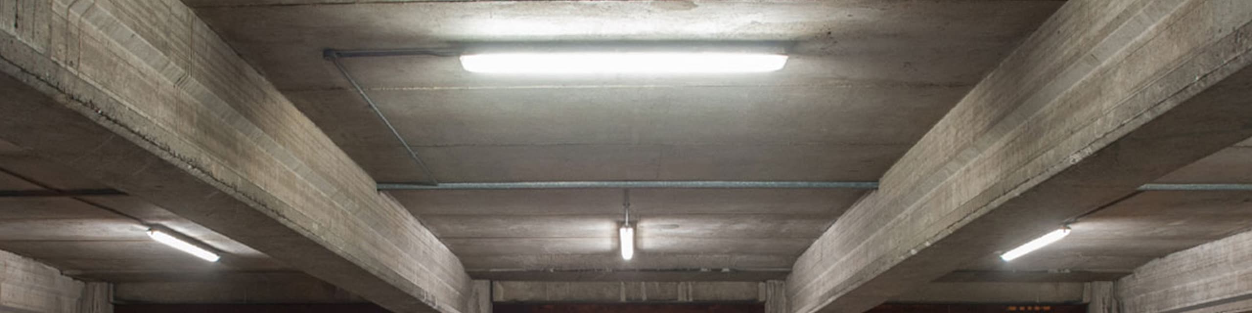 Concrete parking garage ceiling with tube lighting
