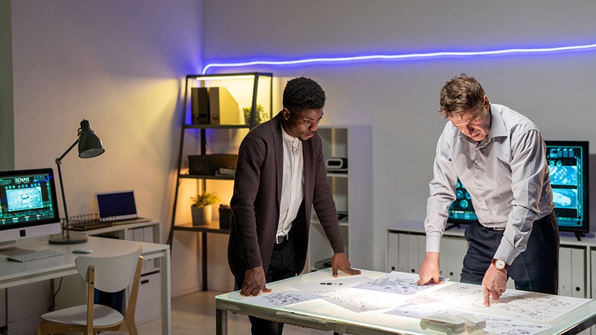 Two people reviewing plans in a modern office