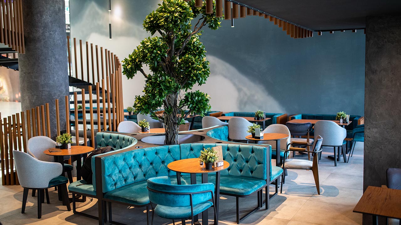 Cafe with teal seating and warm ambient lighting