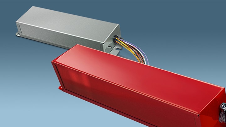 A selection of obsolete Bodine emergency lighting ballasts in red and grey