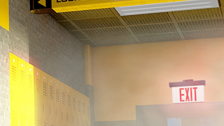 A school hallway lined with bright yellow metal lockers and an illuminated EXIT sign in the background