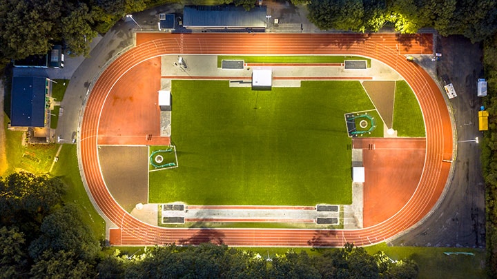 Outdoor sports field, brightly illuminated by stadium lights