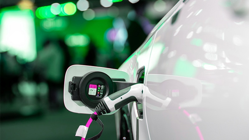 An electric car charging showcases the switch to clean energy