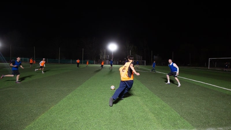 children playing football at night