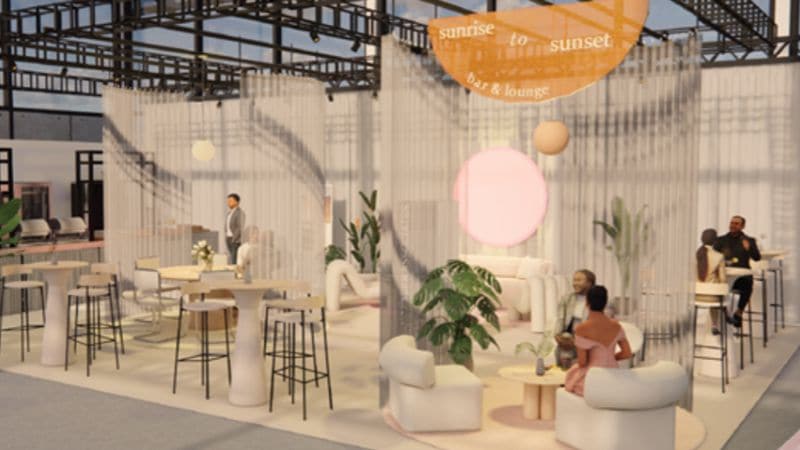 Cityscape viewed from above, framed by lush green plants and trees