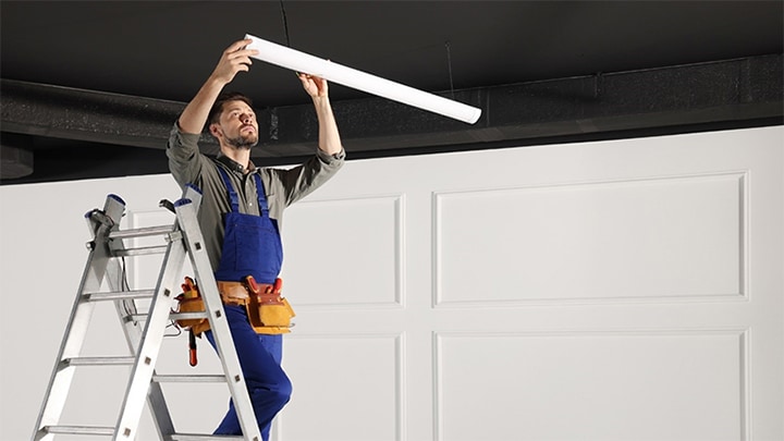  A Man Installing Energy Code Compliant Lighting