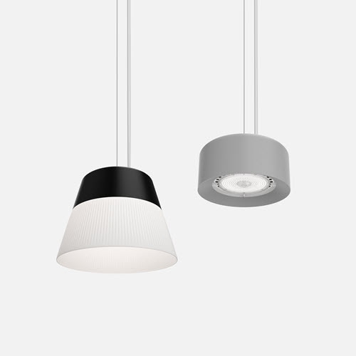 Two pendant lights hanging side by side. The left pendant light features a white dome with a soft, warm glow, while the right pendant light is black with a reflective inner surface, giving a more focused, diffused light. 