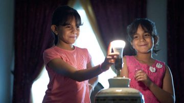 Child holding a light bulb