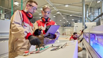 Engineers working with machines and ipad