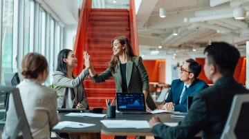 Professionals celebrating in a bright office space