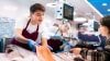 Person handling fresh fish at seafood counter