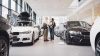 Modern car showroom with white cars and white lighting