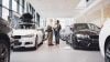 Modern car showroom with white cars and white lighting