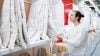 Man shopping for bedding in crisp white lighting