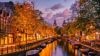 City canal at night with warm golden light