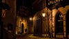Empty city street at night with warm, glowy light