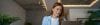 Smiling woman behind laptop